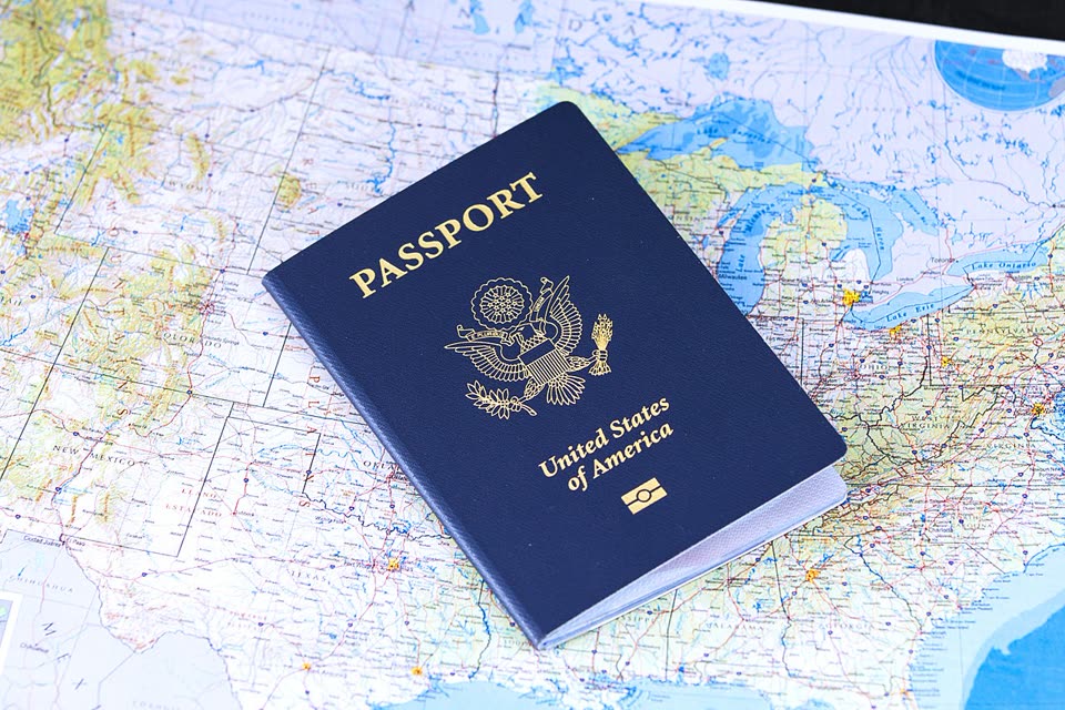 Passport placed on top of a folded map before international travel